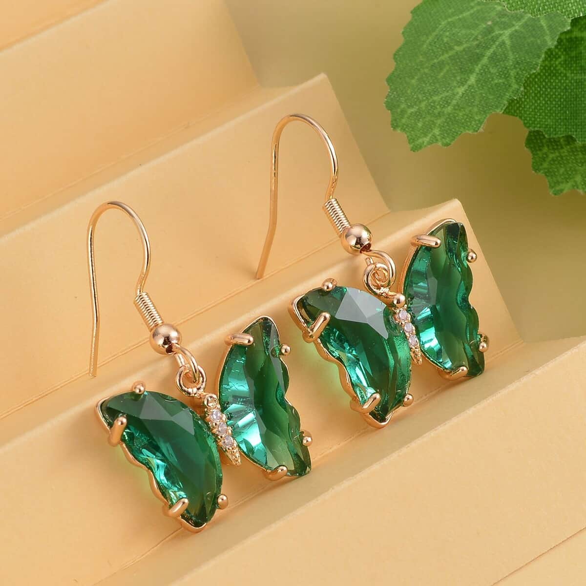 Simulated Dark Green Sapphire and Simulated Diamond Butterfly Earrings in Goldtone 0.10 ctw image number 1