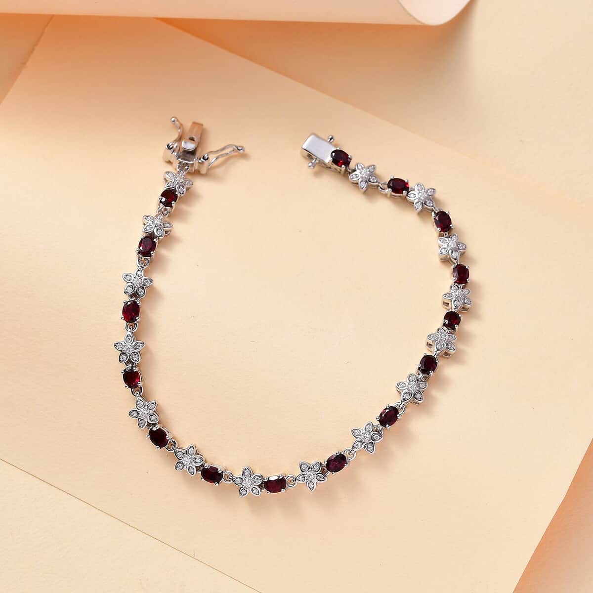 Premium Anthill Garnet and Moissanite 5.30 ctw Flower Bracelet in Rhodium Over Sterling Silver (7.25 In) image number 1