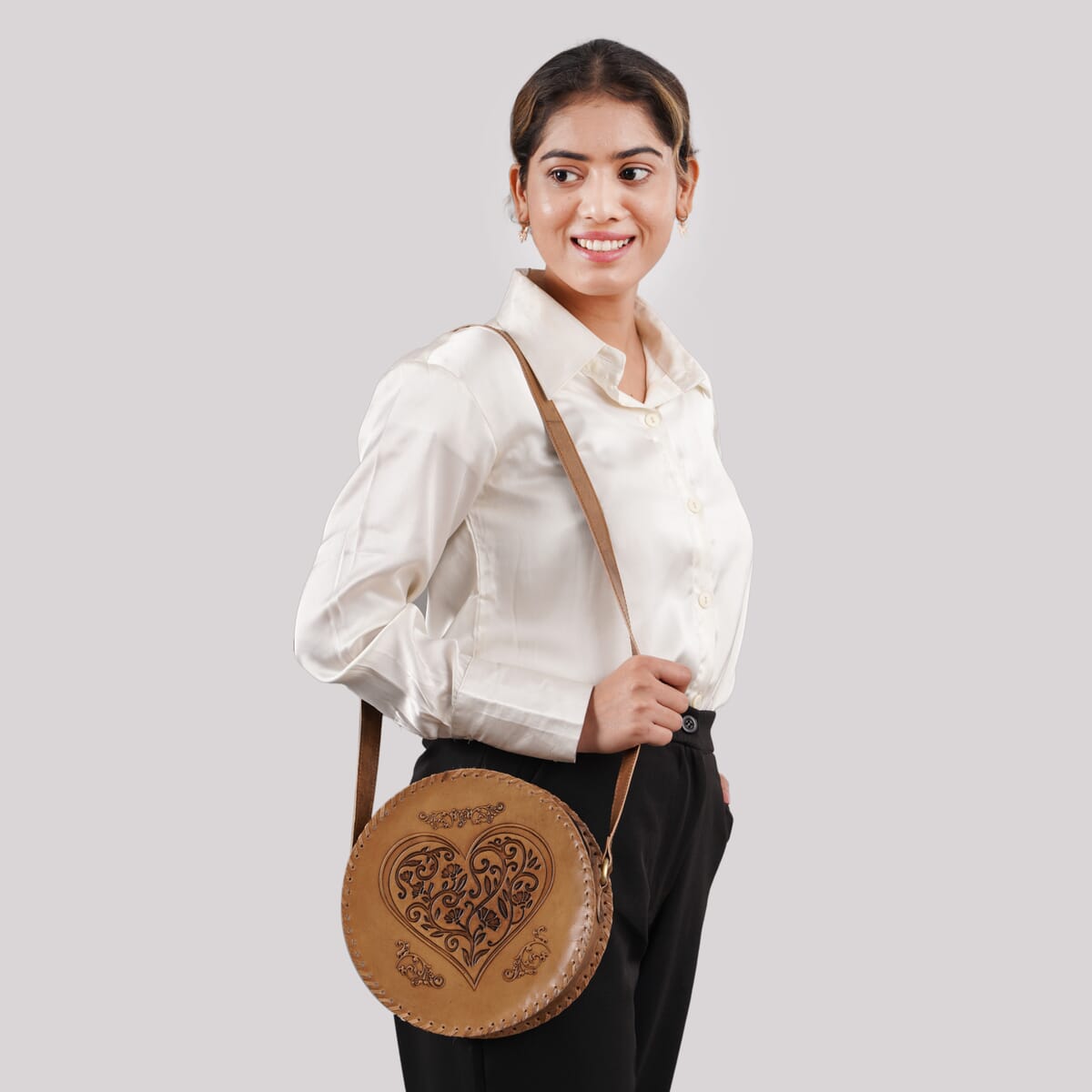 Tan Heart Pattern Genuine Leather Round Embossed Sling Bag with Adjustable Shoulder Strap image number 1