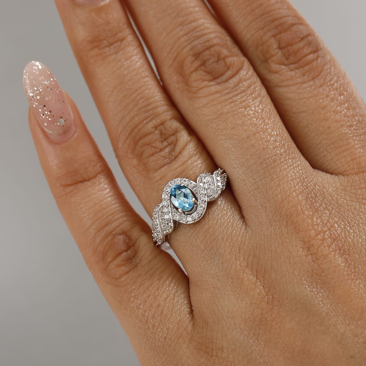 Premium Betroka Blue Apatite and White Zircon 1.10 ctw Swirl Infinity Sparkle Ring in Rhodium Over Sterling Silver (Size 8.0) image number 2