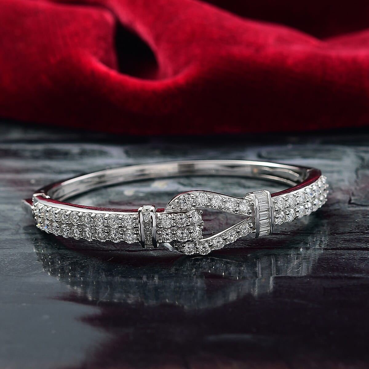 D'Joy Moissanite 5.90 ctw Loop Knot Bangle Bracelet in Rhodium Over Sterling Silver (7.25 In)  image number 1