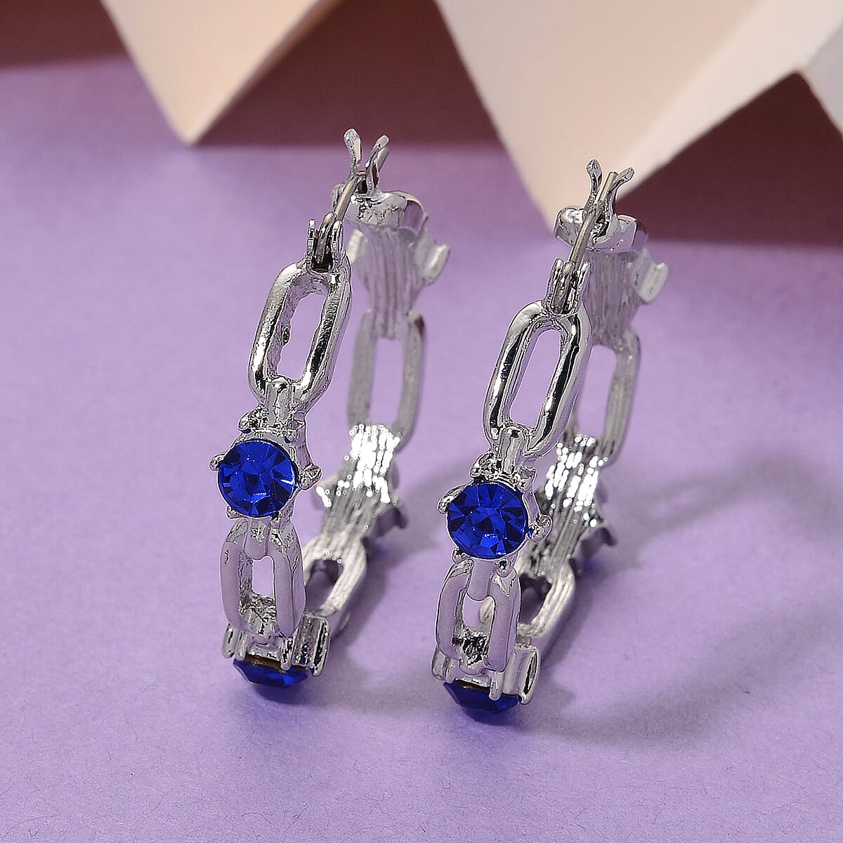 Doorbuster Blue Austrian Crystal Paperclip Chain Hoop Earrings in Silvertone image number 1