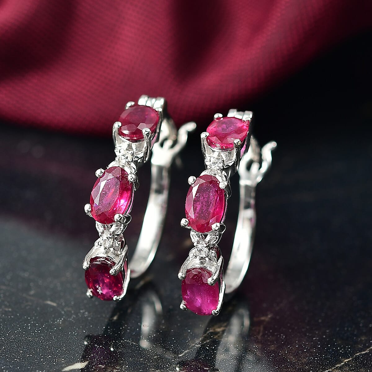 Doorbuster D'Joy Niassa Ruby (FF) and White Zircon 3.80 ctw Four Leaf Clover Hoop Earrings in Rhodium Over Sterling Silver image number 1
