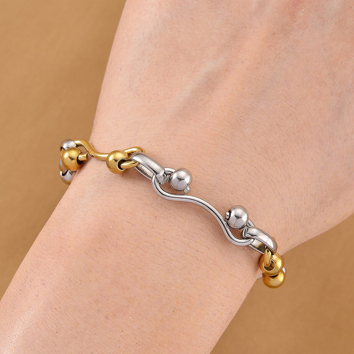 Modern Wave Link Chain Bracelet in ION Plated YG and Stainless Steel (7.00 In) image number 1