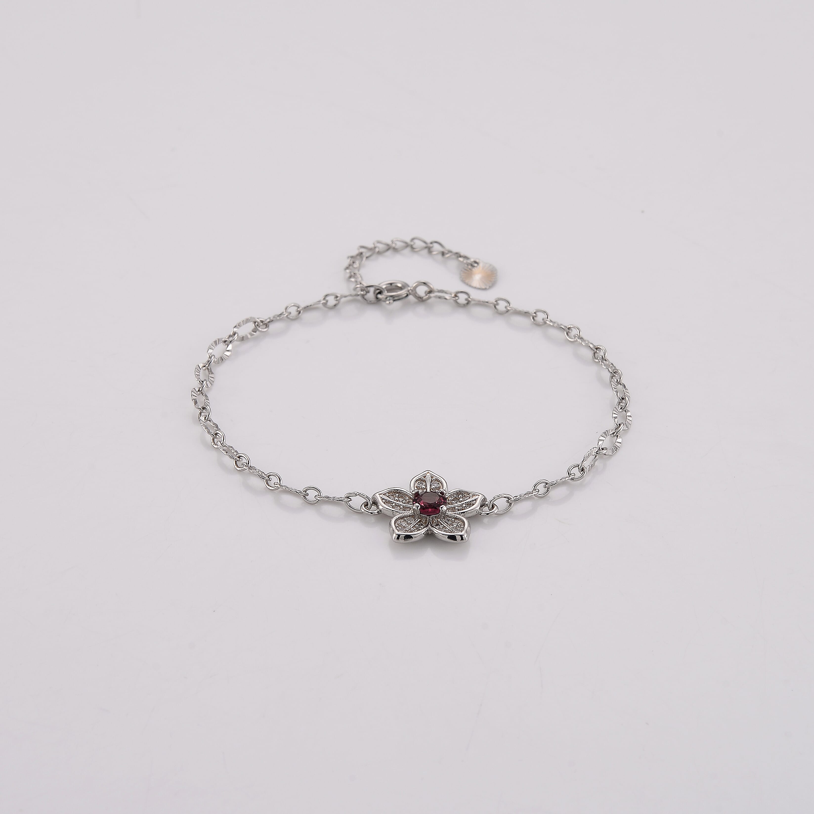 Mozambique Garnet and Simulated Diamond 0.30 ctw Bracelet in Silvertone (6-7In)