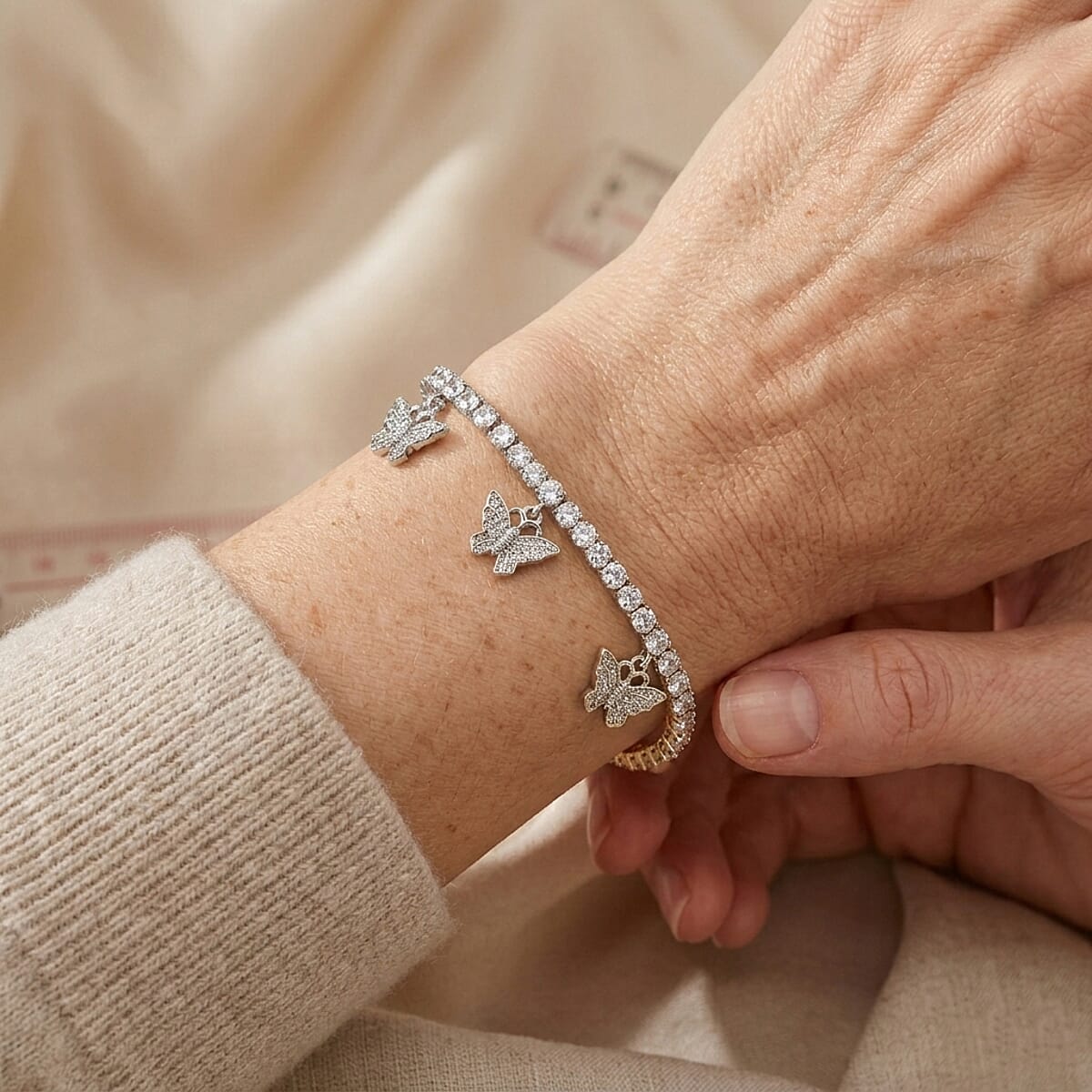 Simulated Diamond Tennis Bracelet with Hamsa Charms in Silvertone (7.25 In) 3.00 ctw image number 1
