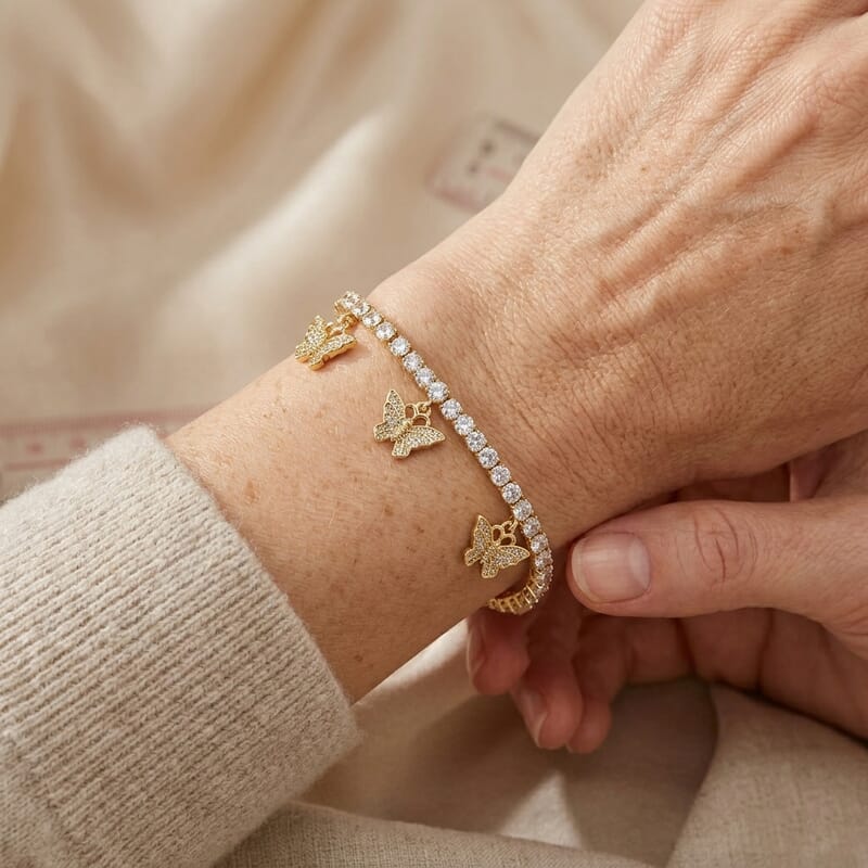 Simulated Diamond Tennis Bracelet with Butterfly Charms in Goldtone (7.00 In)