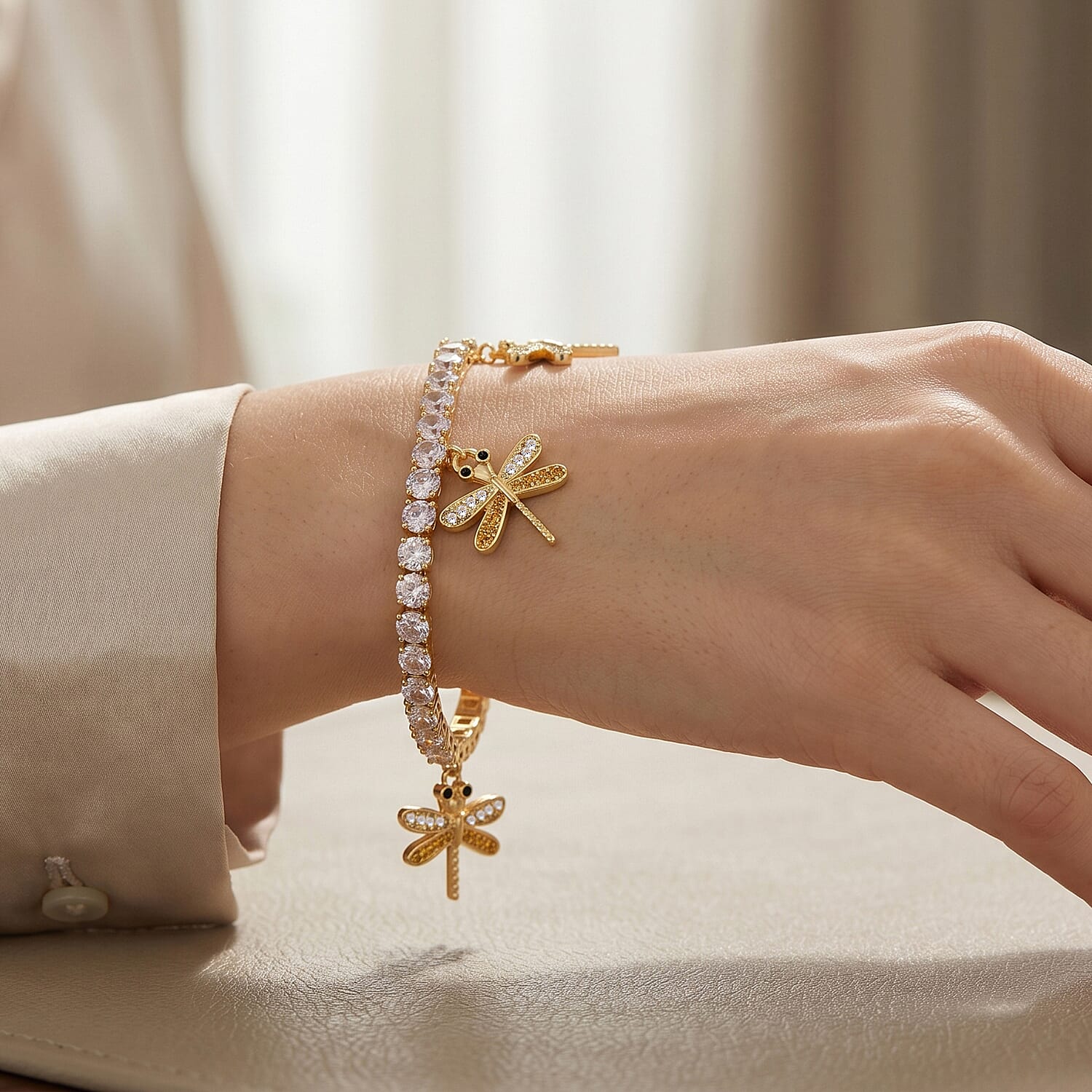 Simulated Black and White Diamond Tennis Bracelet with Dragonfly Charms in Goldtone (7.25 In)