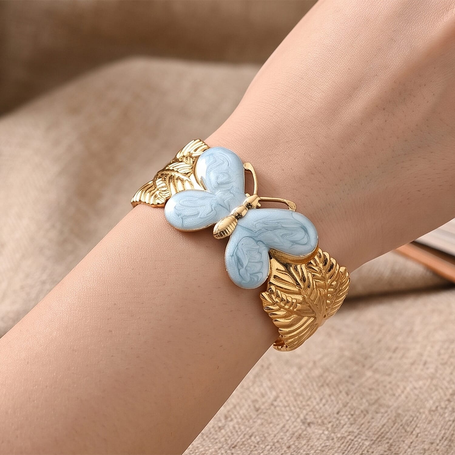 Fashionable Blue Enameled Butterfly Cuff Bracelet in ION Plated YG Stainless Steel (6.5-7In)