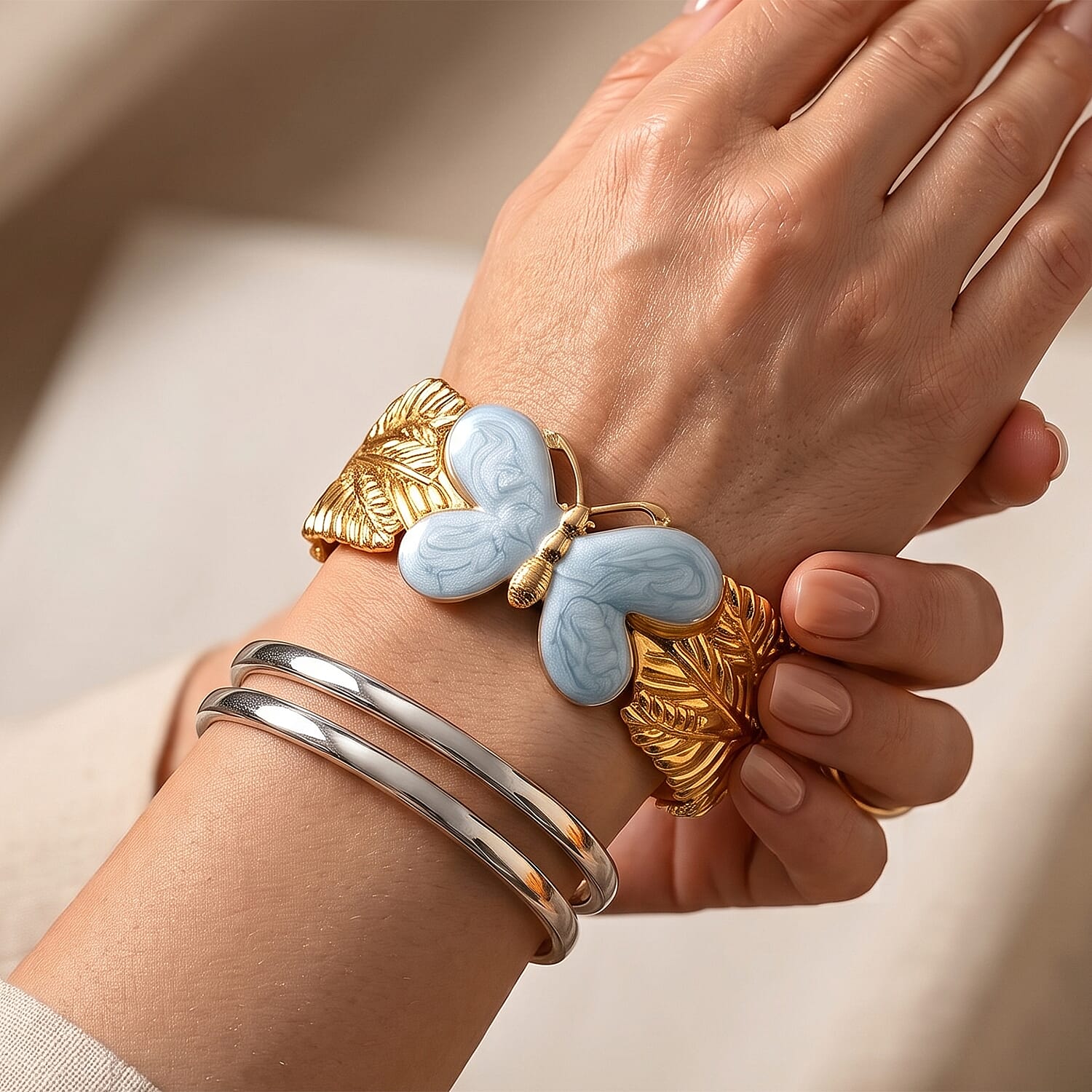 Fashionable Blue Enameled Butterfly Cuff Bracelet in ION Plated YG Stainless Steel (6.5-7In)