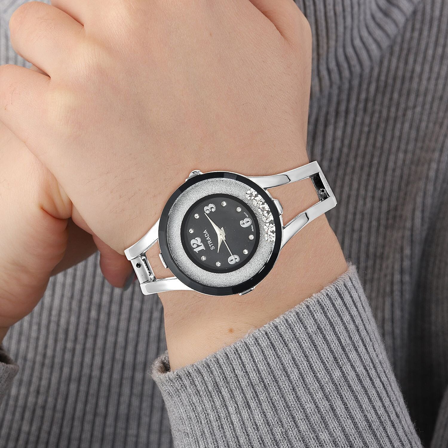 Strada Moving Austrian Crystal Japanese Movement Black Dial Watch with Silvertone Strap (32.51 mm) (up to 6.50 Inches)