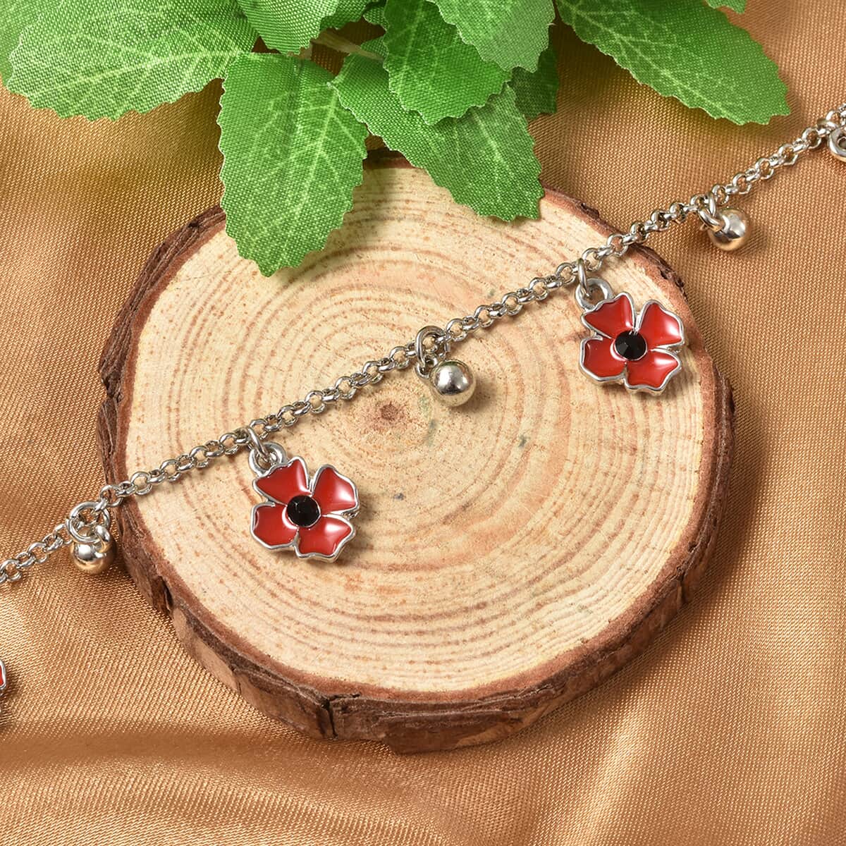 Black Austrian Crystal and Enameled Adjustable Poppy Charm Bracelet in Silverton image number 1