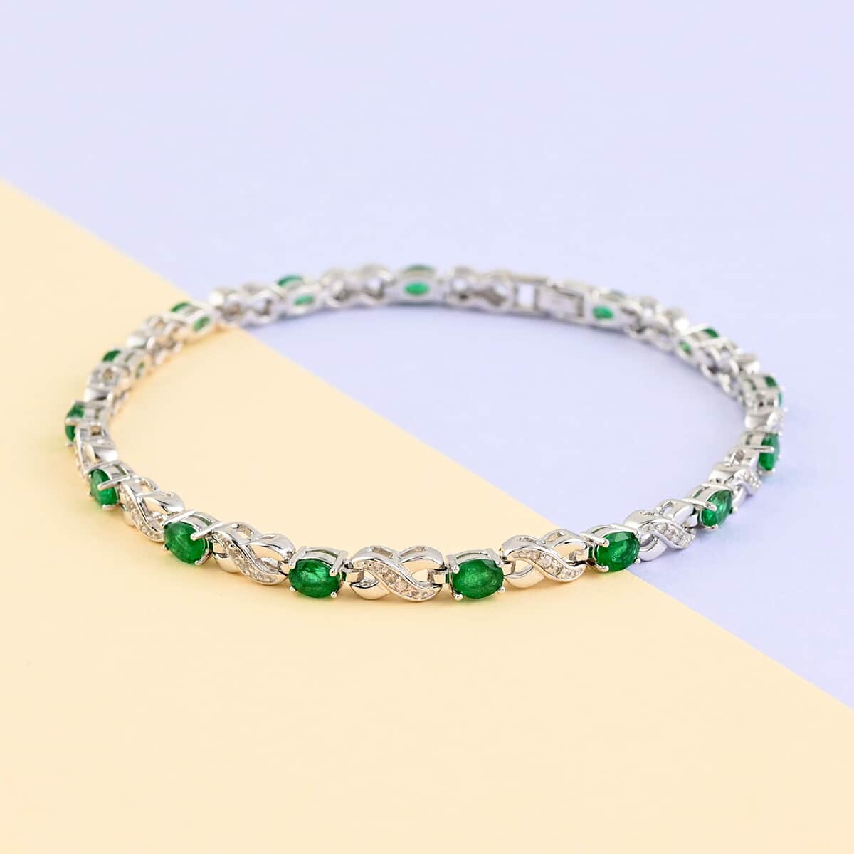 AAA Kagem Zambian Intense Green Emerald and Natural White Zircon Infinity Link Tennis Bracelet in Rhodium Over Sterling Silver (7.00 In) 2.75 ctw image number 1